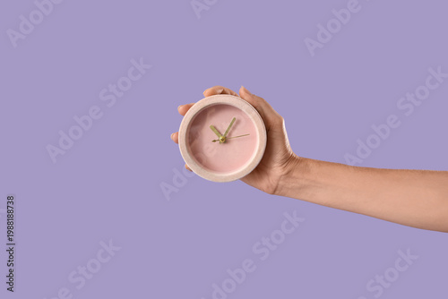 Female hand with alarm cloc...