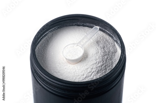 Spoon with creatine proteine in an opened can for sporty lifestyle, isolated on white. 
