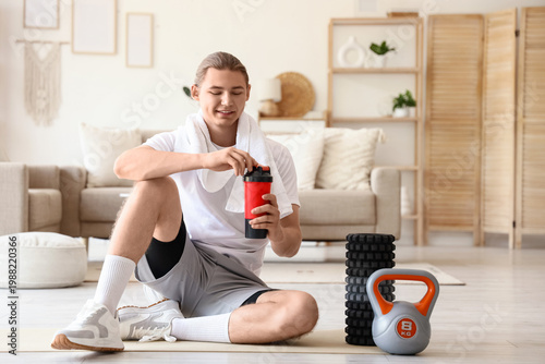 Sporty young man with towel...