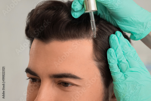Doctor applying serum for h...
