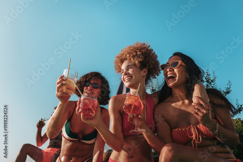 Konstfotografi Diverse friends enjoying summer pool party with refreshing cocktails