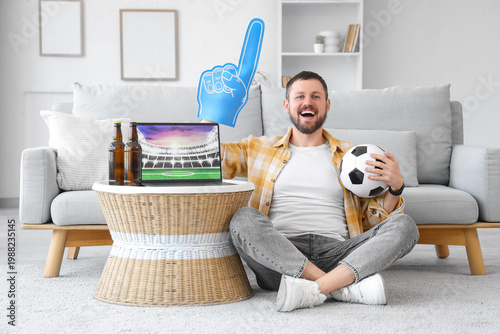 Happy young man with soccer...