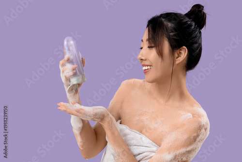 Smiling young woman wrapped...