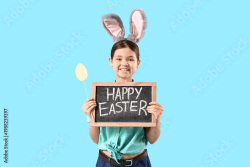 Cute girl in bunny ears hol...