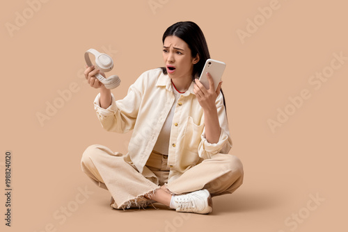 Shocked young woman with he...