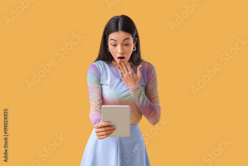 Shocked young woman using t...