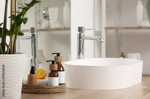Tableau sur toile Natural cleaning supplies with lemon on table in bathroom
