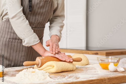 Woman rolling out fresh dou...