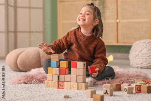 Happy little girl playing w...