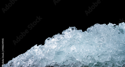 Bild auf Leinwand Pile of crushed ice cubes on dark background, cold fresh texture for beverages like beer whisky juice and milk, cooling concept for food preservation and refreshing drinks with crystal clear surface