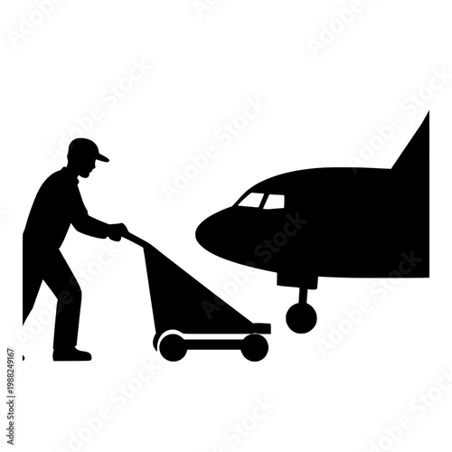 Silhouette of a man pushing a luggage cart toward an airplane