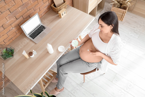 Young pregnant woman applyi...