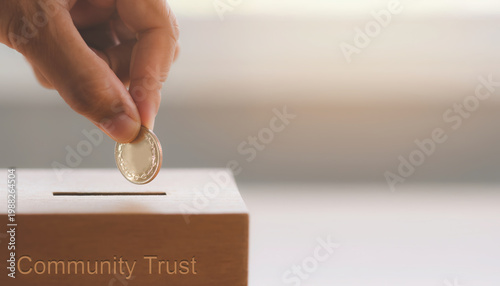 Ethical finance donation hand coin box trust charity saving concept warm light hope