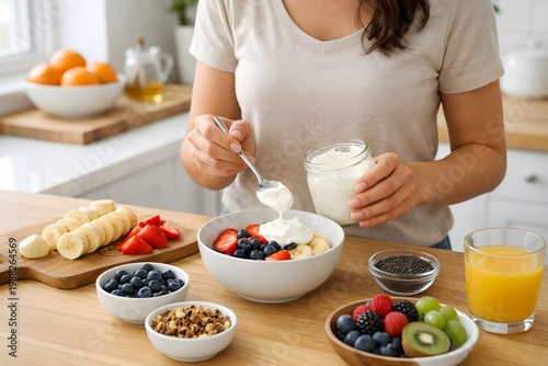 Woman Prepare Healthy Breakfast Bowl with Fresh Fruit and Yogurt in a Bright Kitchen