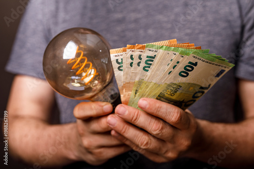 Person holding lightbulb wi...