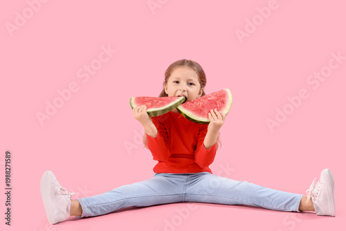 Happy little girl eating fr...