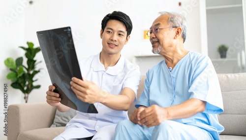 Asian male nurse explaining medical x-ray results to an elderly patient in a hospital room, healthcare consultation, diagnosis, professional support