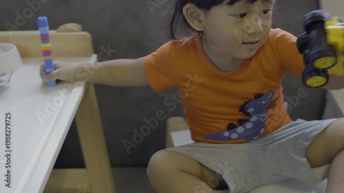 Toddler Playing Building Blocks on Bed, Charming footage of a toddler focused on building blocks while sitting on bed, for child development documentary and family lifestyle content.