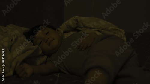Child Is Sleeping On The Bed In The Afternoon, A serene documentary film of a child sleeping on the bed in soft afternoon light, perfect for a peaceful family or nap time heritage.
