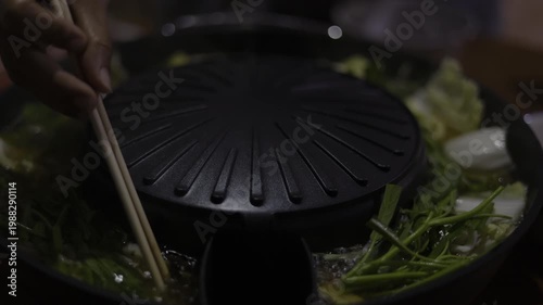 Cooking Vegetables Meat Shabu Hot Pot BBQ Grill Pan, A vibrant video of vegetables and meat sizzling on shabu hot pot BBQ grill pan, capturing authentic dining, for food documentary and culinary.
