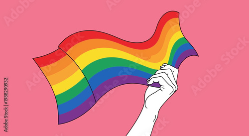 Hand holding rainbow flag waving against pink background, LGBTQ pride symbol