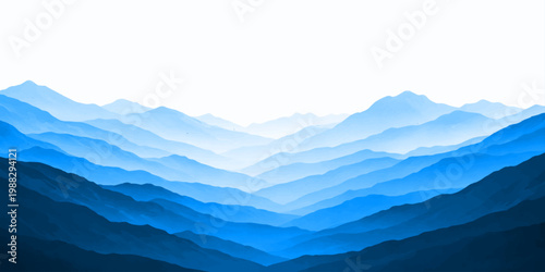 A misty morning sunrise paints the blue horizon as fog settles over a snowy winter mountain landscape in the Alps valley