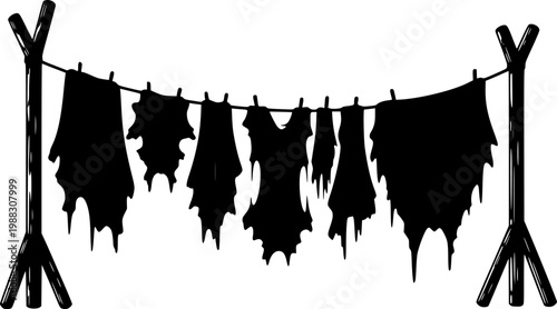 Silhouette of animal hides drying on a line between two wooden stands outdoor isolated on white background
