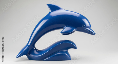 A striking sculpture of a glossy blue dolphin leaping, artistic and elegant