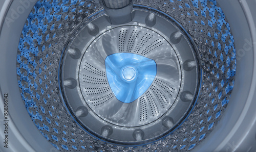 Bild auf Leinwand Interior view of an empty washing machine drum featuring a stainless steel textu