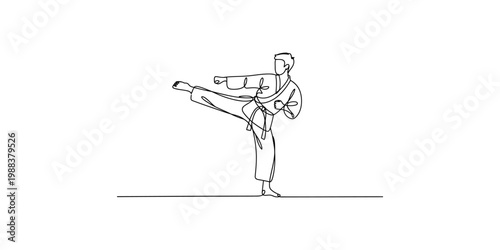 A man in a karate uniform performing a high kick isolated on white background