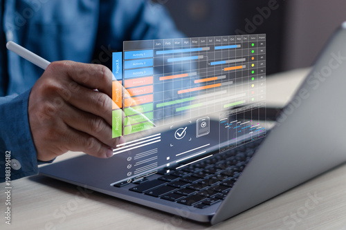 Принти на полотні Businessman using digital project management dashboard with Gantt chart on lapto