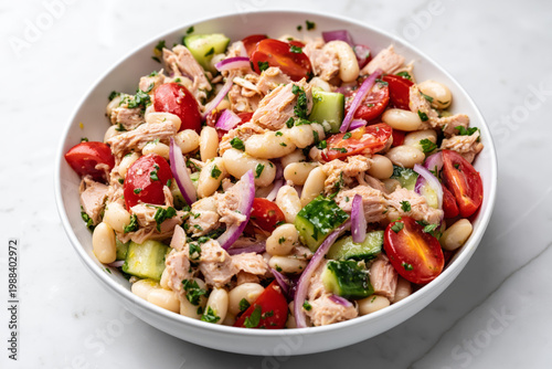 high protein tuna and white bean salad fully mixed in a white ceramic bowl