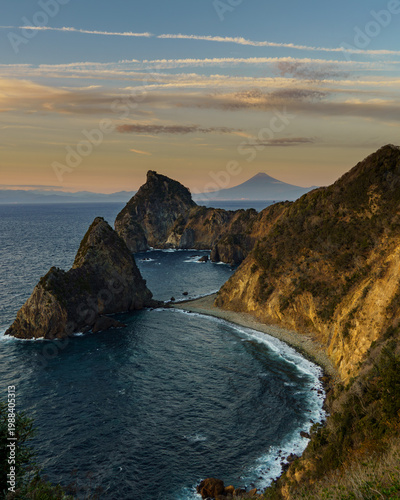 Dramatic sunset landscape of the rugged coastline and cliffs of Nishi-Izu with Mount Fuji in the distance, Shizuoka, Japan.