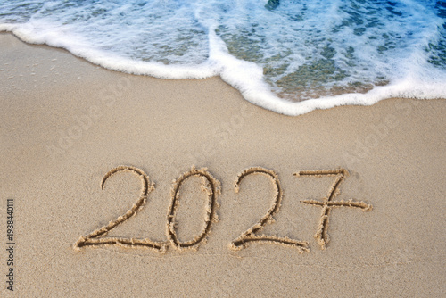 New Year 2027 background with hand written in the white Caribbean sea beach.