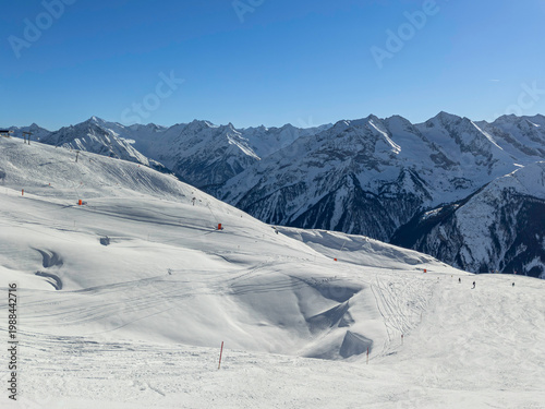 Skiing in the Alps: A Stunning View of Snowy Slopes and Distant Peaks