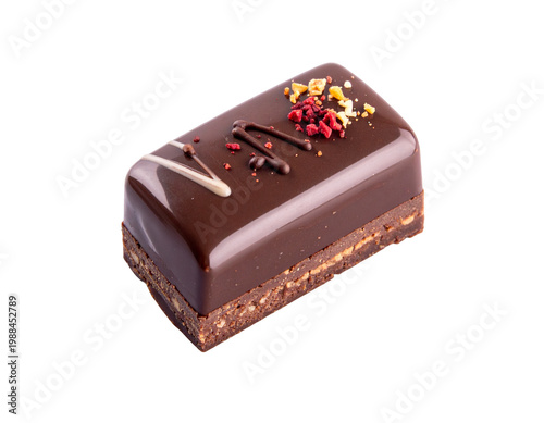 Chocolate ganache petit four with glossy finish and crumble garnish on dark chocolate layer