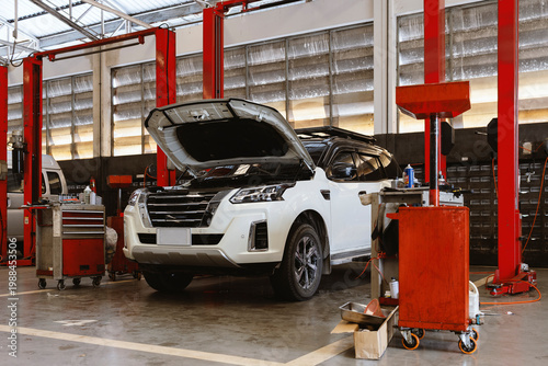 Cars on Hydraulic Lifts Inside Modern Auto Repair Service Garage