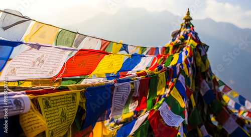 Colorful prayer flags and a buddhist stupa amidst misty mountains
