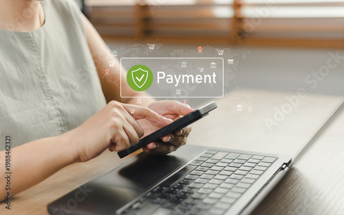 Woman using smartphone and laptop for secure online payment with virtual icon interface. Concept of mobile banking, digital transaction, e-commerce security, and financial technology at home