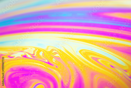 Macro photo of soap bubble surface with colorful abstract pattern and rainbow reflections