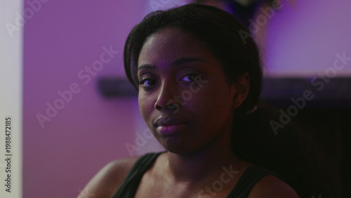 Картината върху платно African American woman close up looking forward with soft neutral expression con