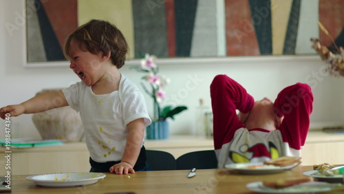 Konstfotografi Toddler tries grabbing older brother mug at breakfast leading to crying conflict