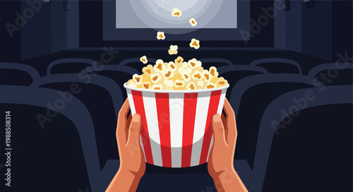 Hands holding a striped bucket of popcorn inside a dark movie theater auditorium