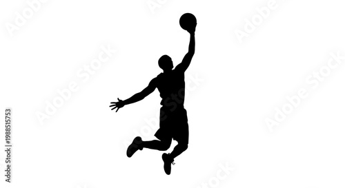 Fotografie A silhouette of a basketball player jumping to dunk a ball in mid-air