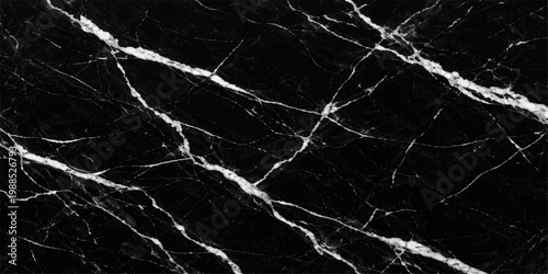 An abstract black and white grunge texture captures a rough dark marble surface with an old stone pattern and natural granite material for a weathered wall backdrop design