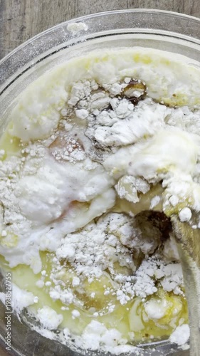 Adding corn kernels to cornbread batter vertical
