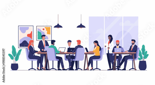 Colleagues collaborate at a meeting table with laptops in a modern office setting