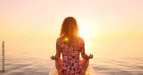 A happy young woman walking on a sup board by the sea during her summer vacation. Slow motion