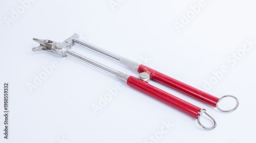 Medical tool with red handles isolated on white background