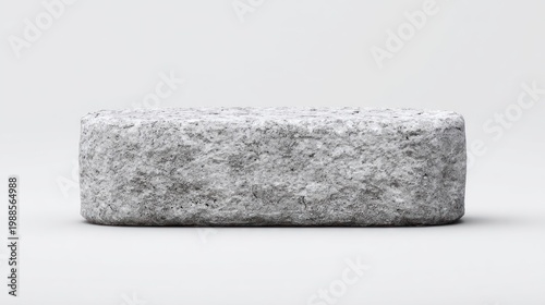 Close up of a weathered gray rectangular stone on a plain white background